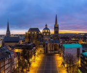 The cathedral of Aachen in Germany at the blue hour with sunset panorama. UNESCO World Heritage Site building. Taken in outside with a 5D mark III. (https://rcphotostock.com – © rcphotostock (13416))